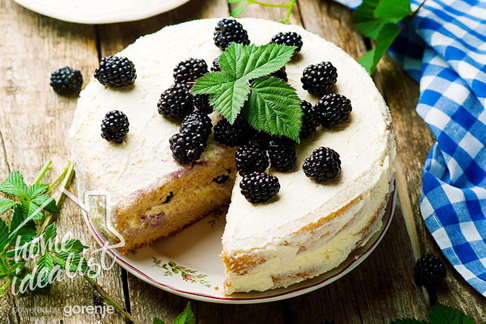 Honey cake with blackberry and whipped cream.