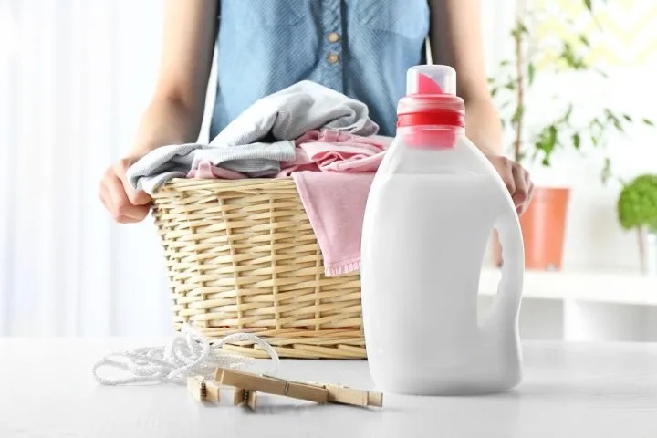 woman_holding_basket_of_clothes_shutterstock_465281252