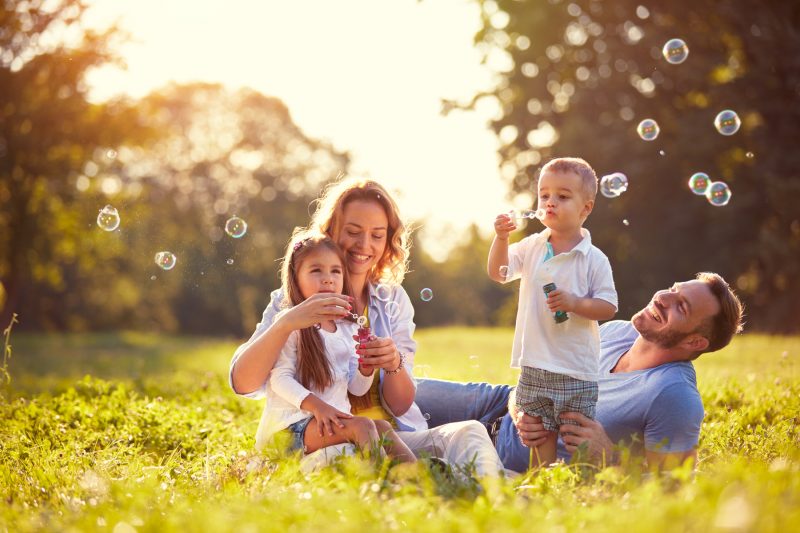 Family,With,Children,Blow,Soap,Bubbles,Outdoor