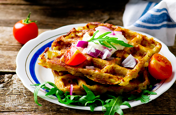 potato waffle with sour cream  and  green salad on a plate.style rustic .selective focus